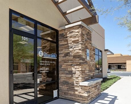 A building with a large stone wall and glass door.