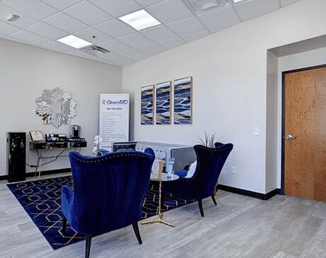 A room with two blue chairs and a table