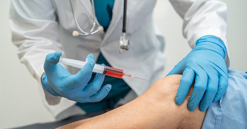 Doctor injecting patient with syringe